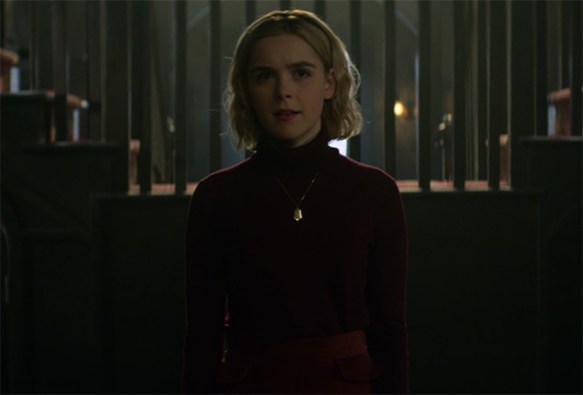 Kiernan Shipka brings warmth to Sabrina in a dark world. Image Credit: Netflix