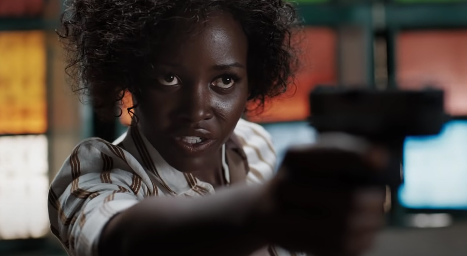 Lupita Nyong'o draws a gun on a goon.