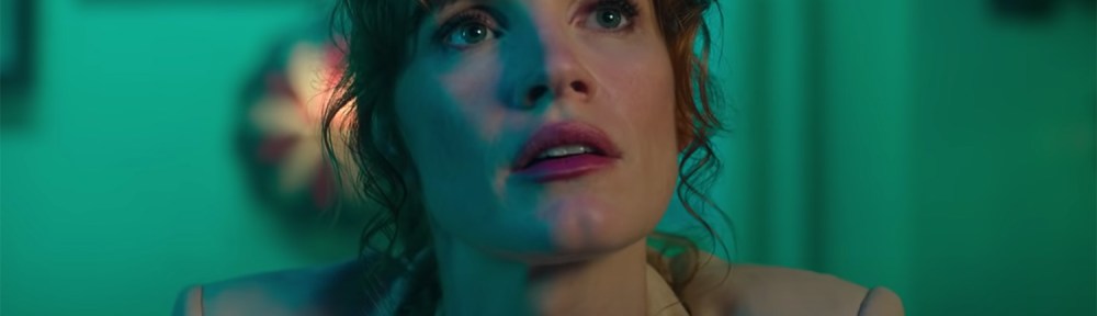 Jessica Chastain looks up at a monitor.