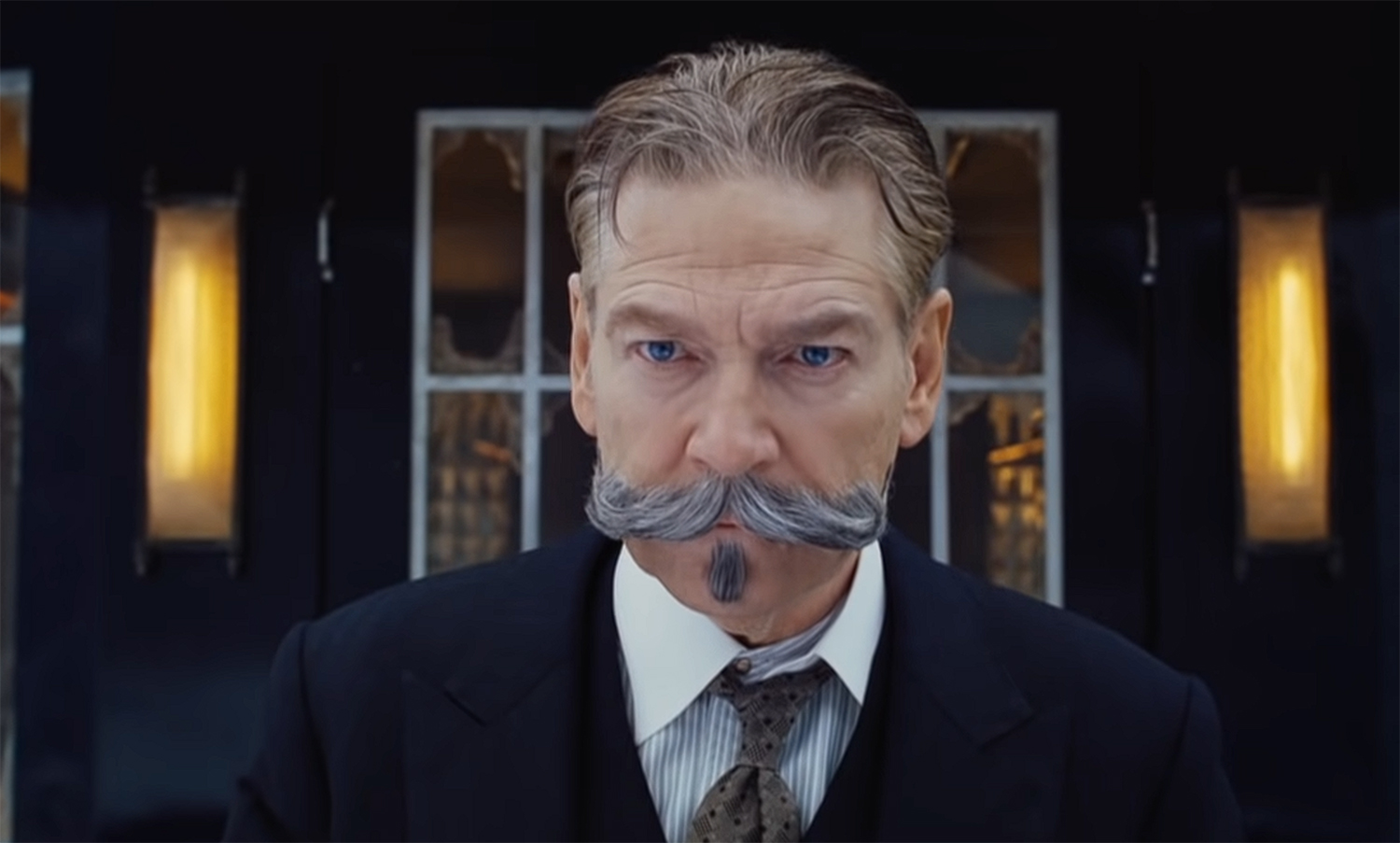 Kenneth Branagh looks out from a train.