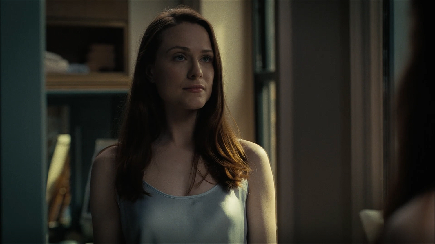 Christina looks at herself in a mirror.