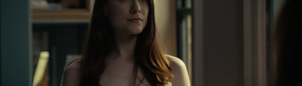 Christina looks at herself in a mirror.