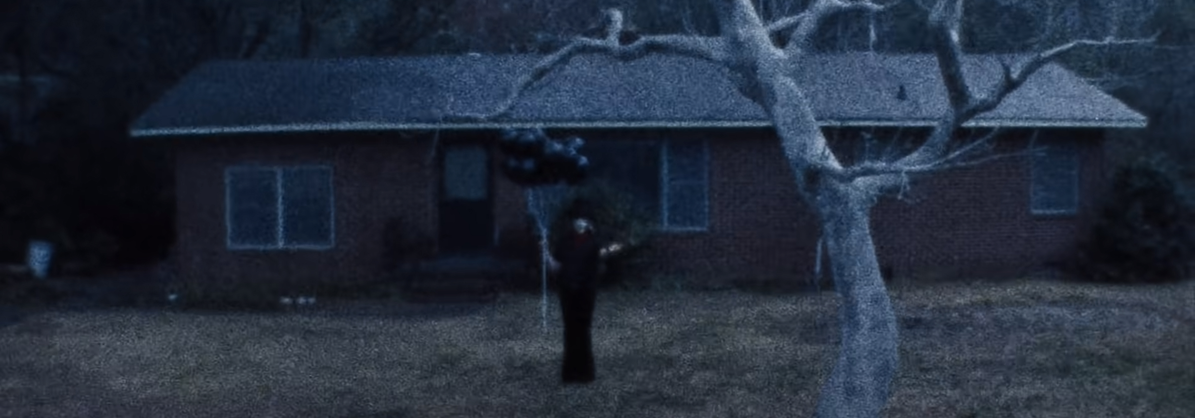 The grabber stands with black balloons.