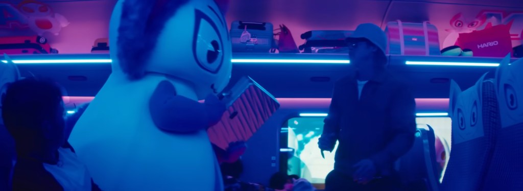 Brad Pitt punching a life sized mascot.