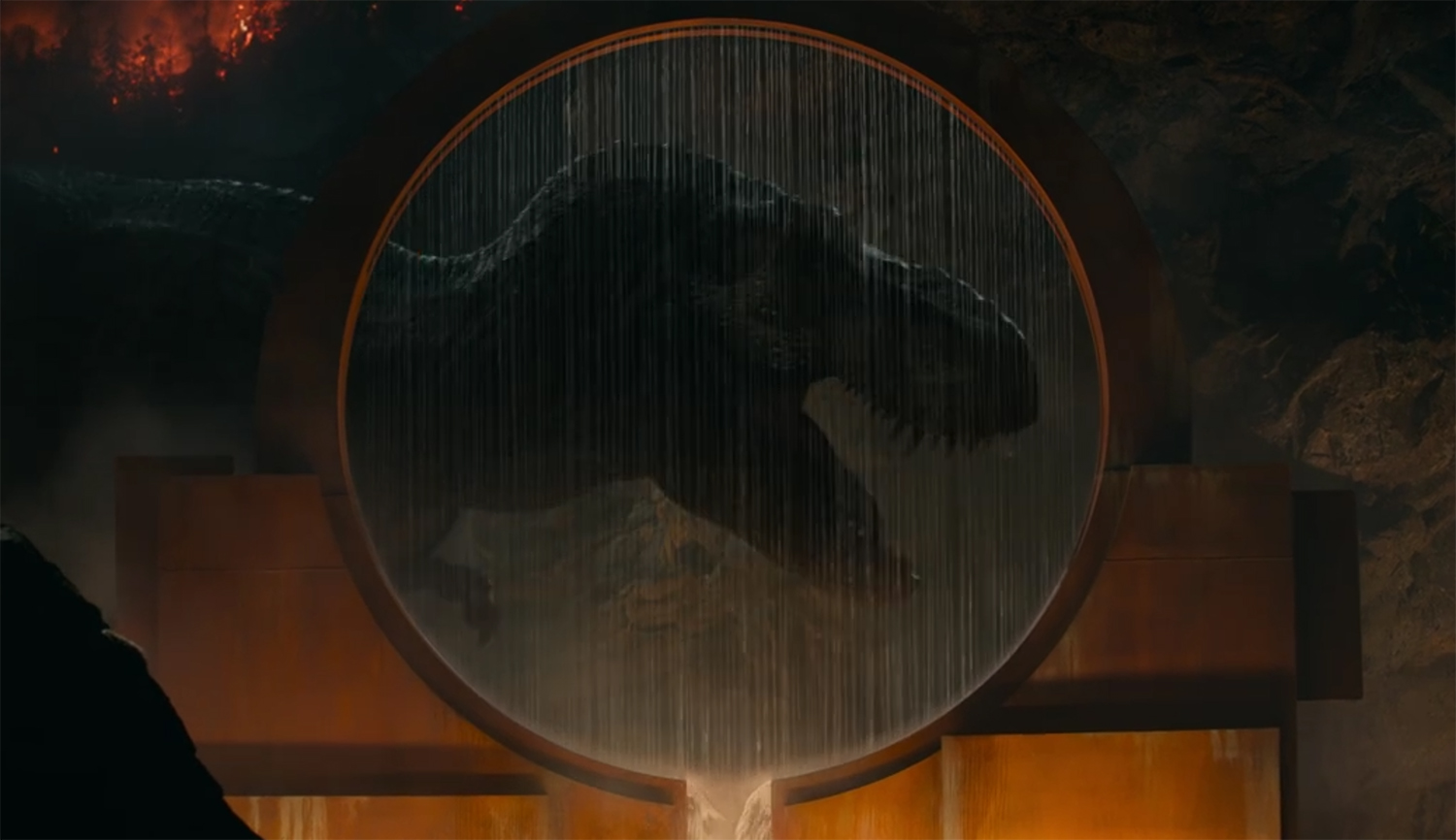 T-Rex roars behind a fountain in a posse reminiscent of the logo.