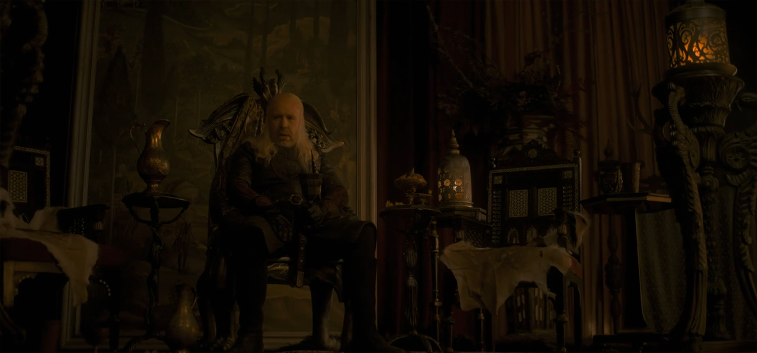 King Viserys I Targaryen alone on a chair.