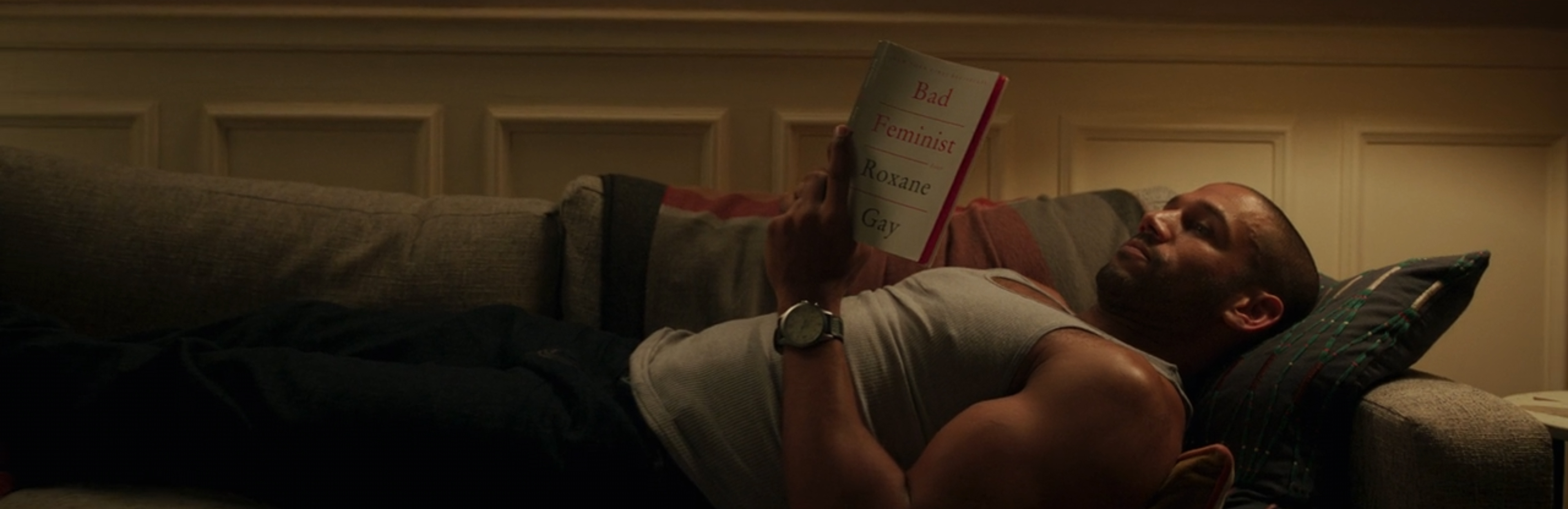 A dude reading 'Bad Feminist' by Roxane Gay.