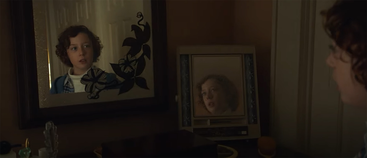 Paul Graff (Banks Repeta) looks in multiple mirros.