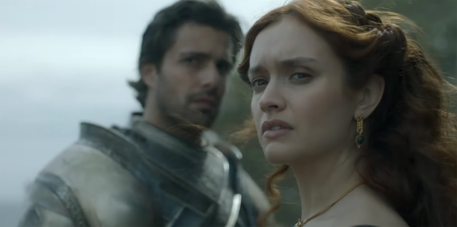 A queen and her knight scan the funeral.