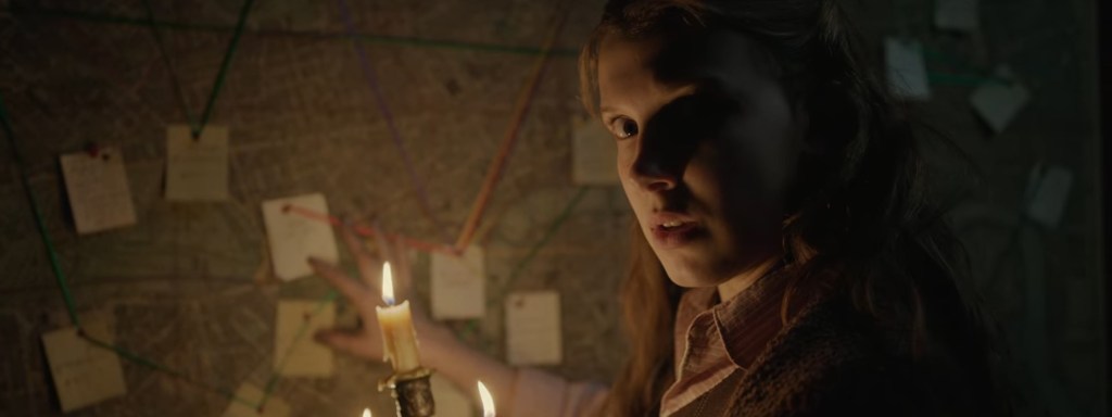 Enola looks at a map.