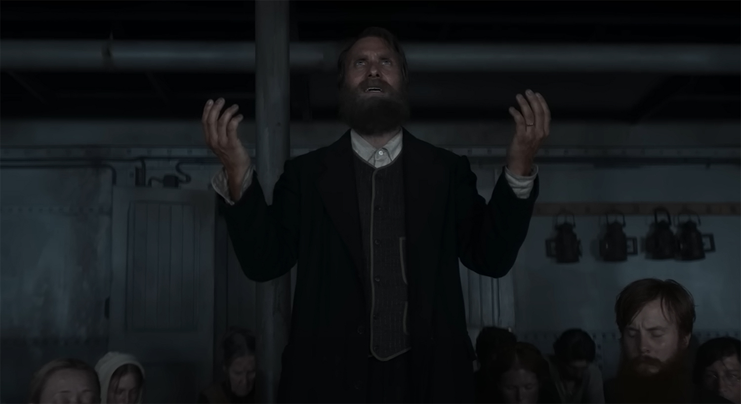 Anker (Alexandre Willaume) leads the Danish passangers in a prayer.