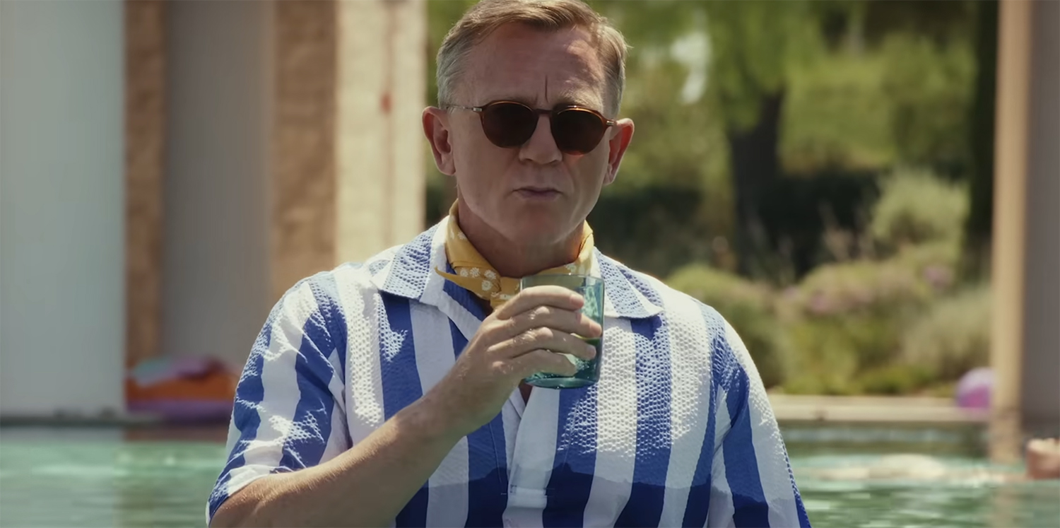 Benoit Blanc in a pool wearing a lounge shirt.