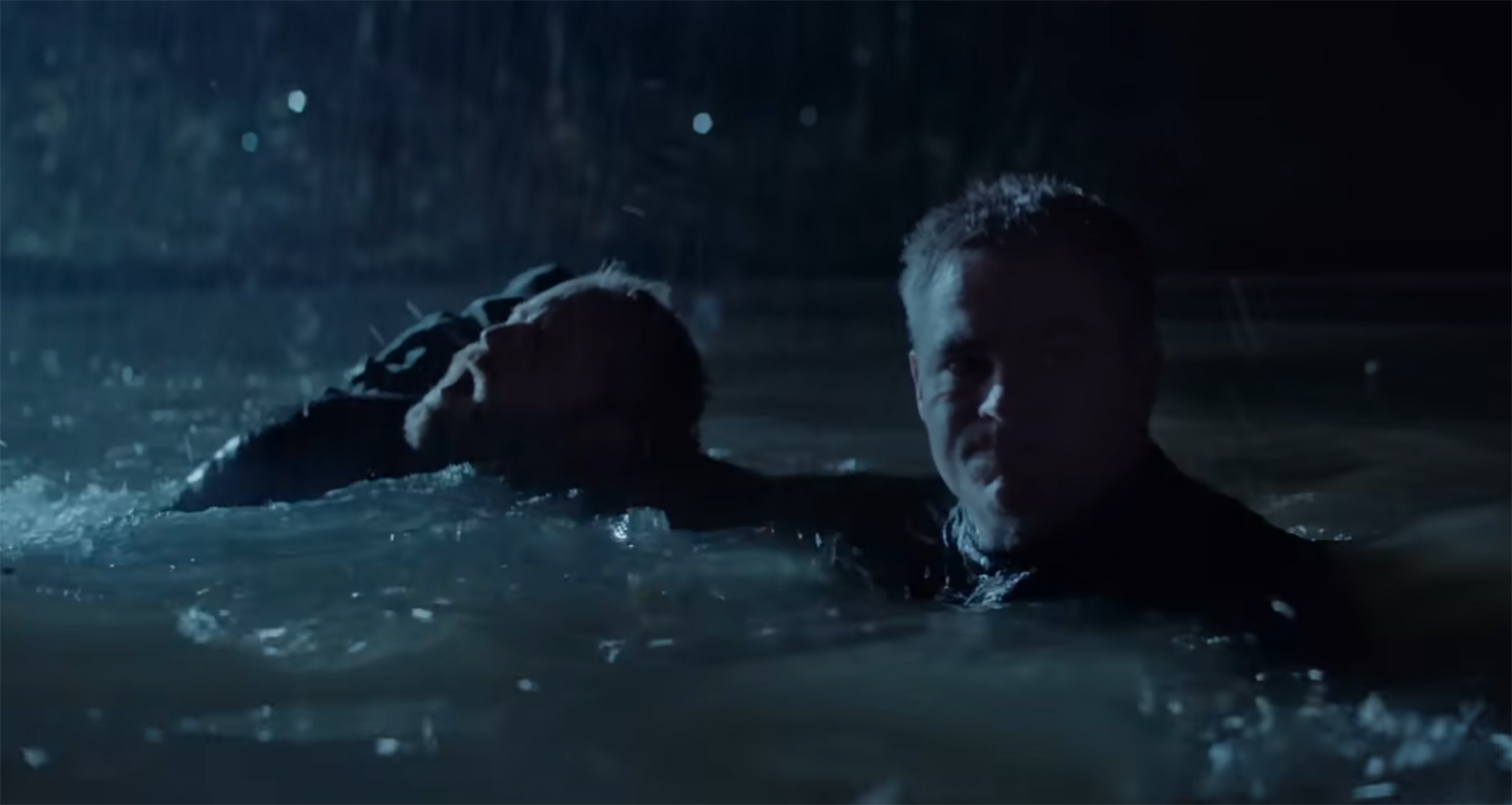 Chris Pine drags Ben Foster through the water.