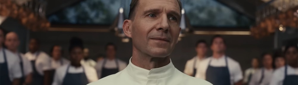 Ralph Fiennes capturing all attention in the room with a clap.