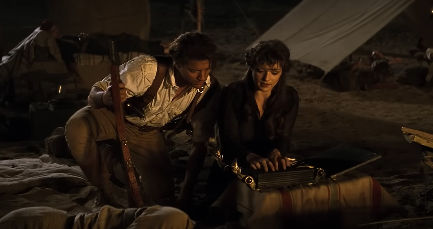 Brendan Fraser and Rachel Weisz read form a book.
