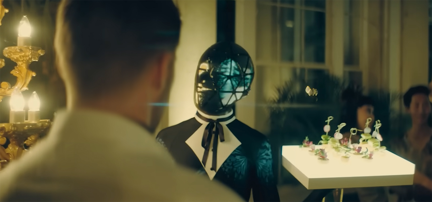 A bot serves food at a party.