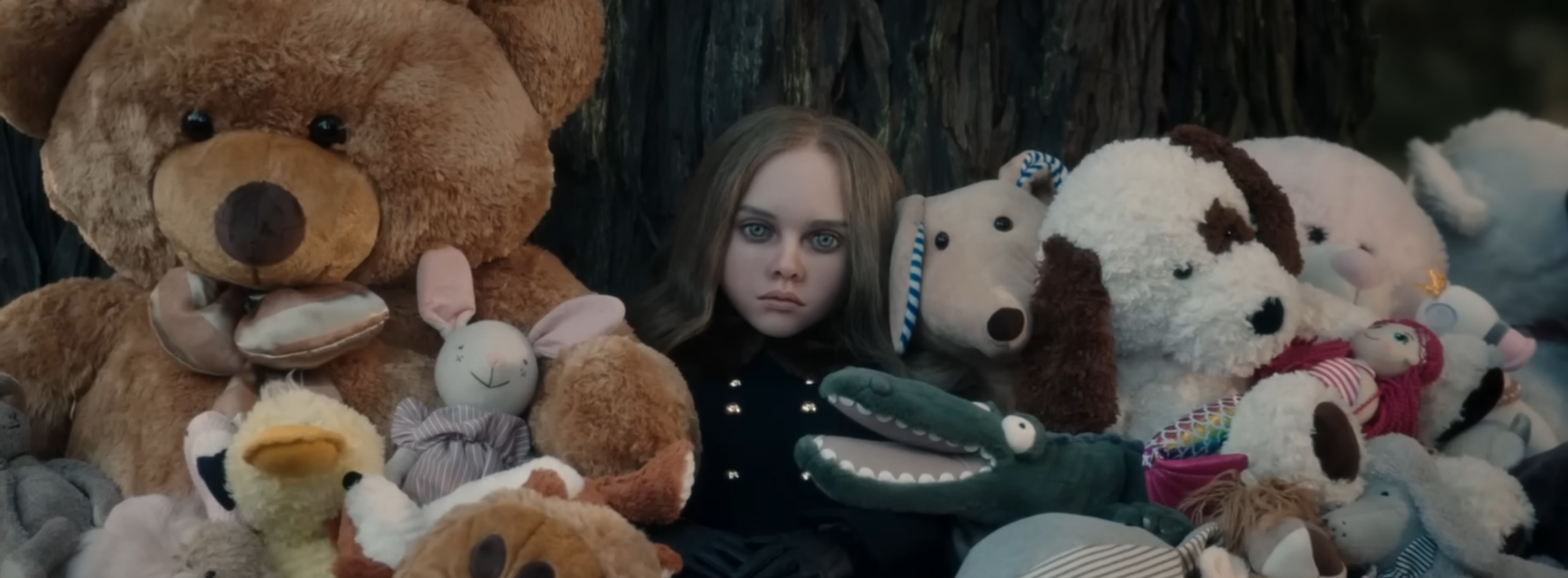 M3GAN in a pile of soft toys.