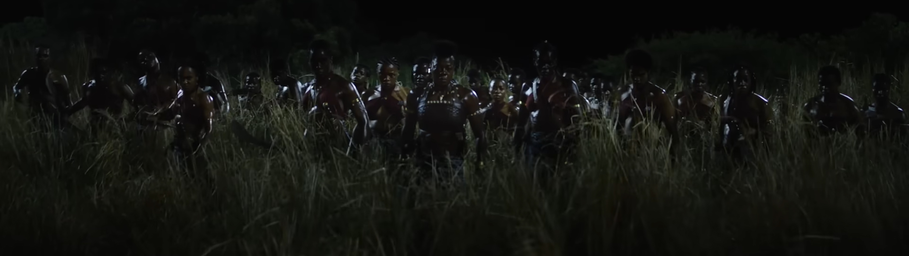 The Agojie rise from the grass.