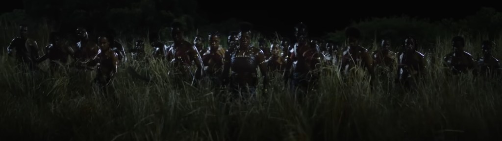 The Agojie rise from the grass.