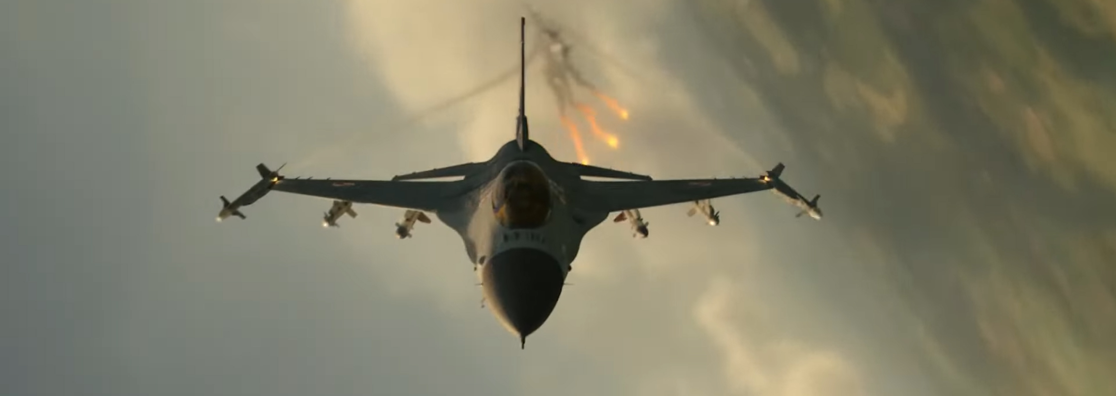 A fighter jet releases flares.