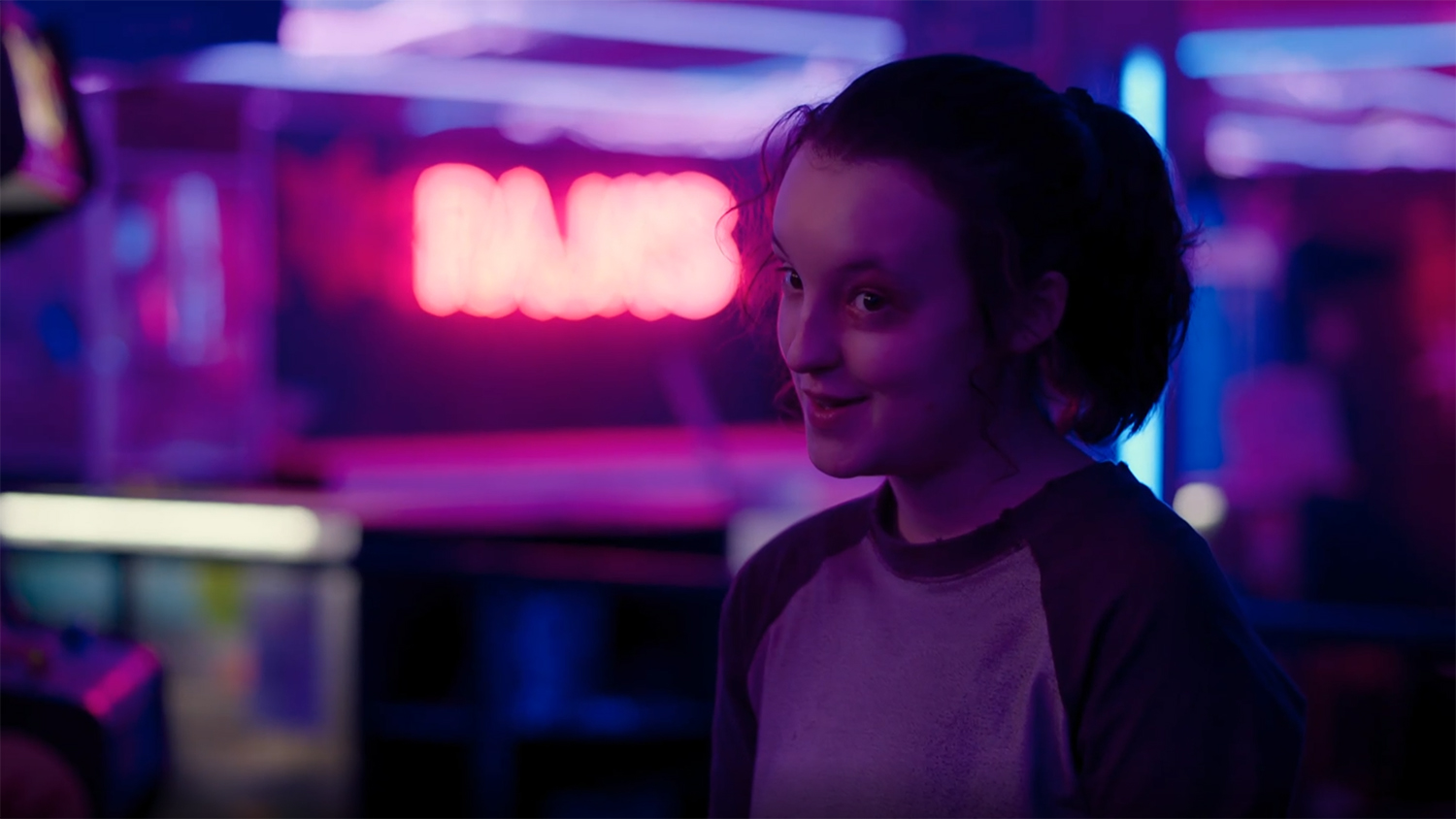 Ellie in a video arcade.