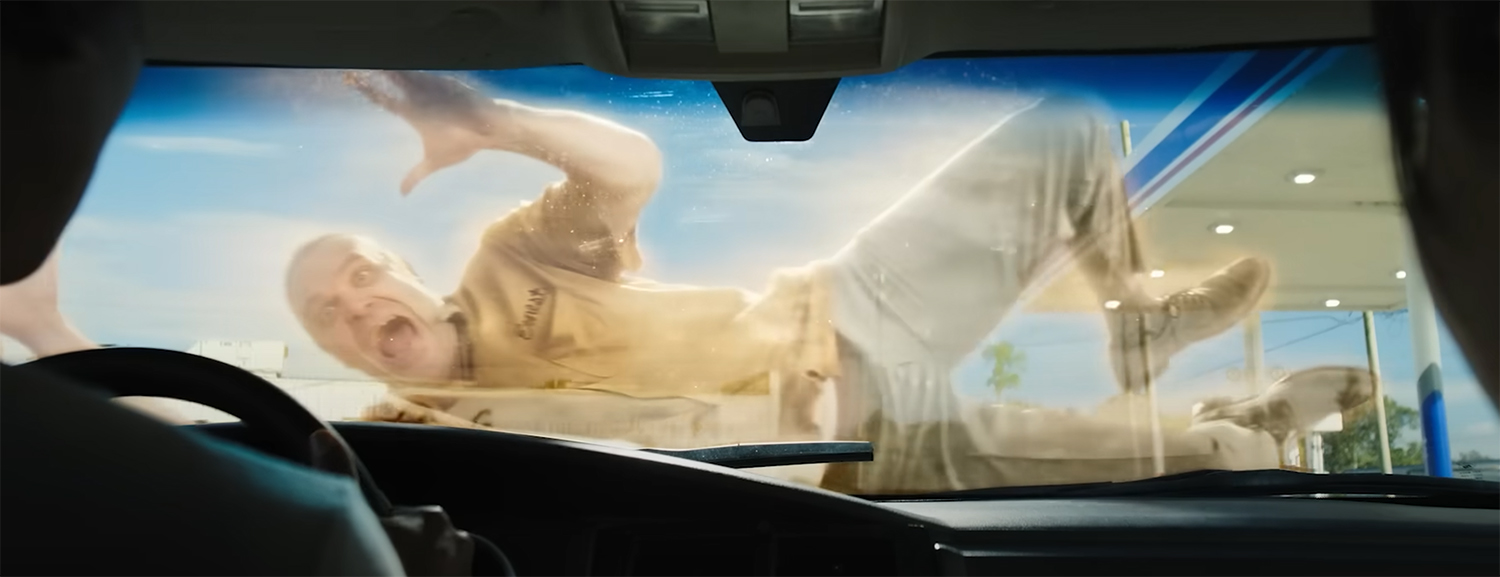 A ghost slides across a car bonnet.