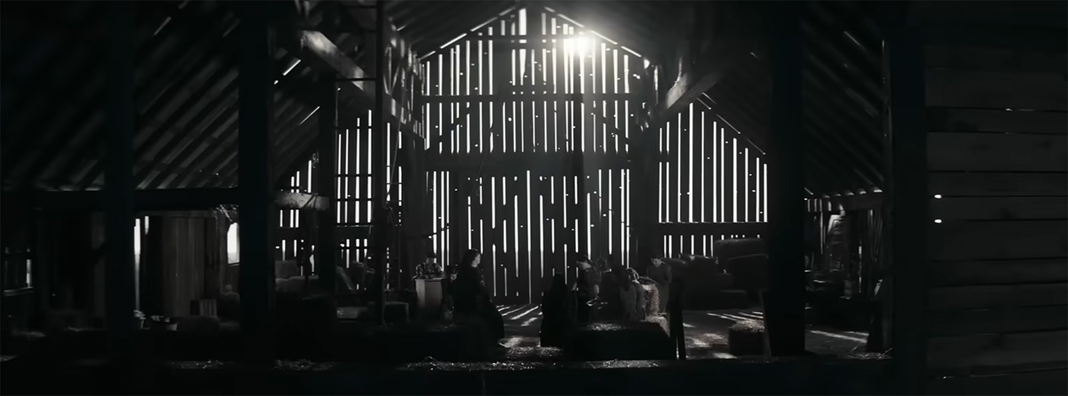 Women discus in a barn.
