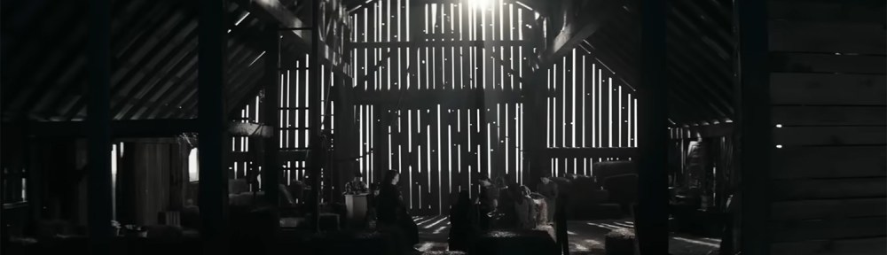 Women discus in a barn.