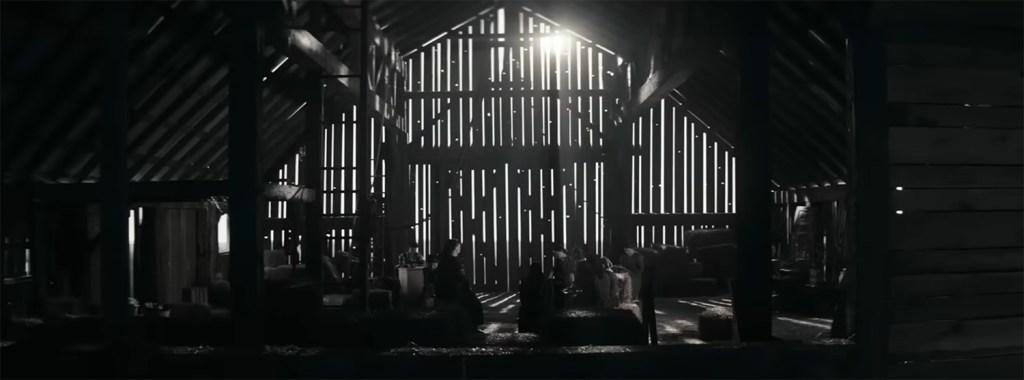 Women discus in a barn.