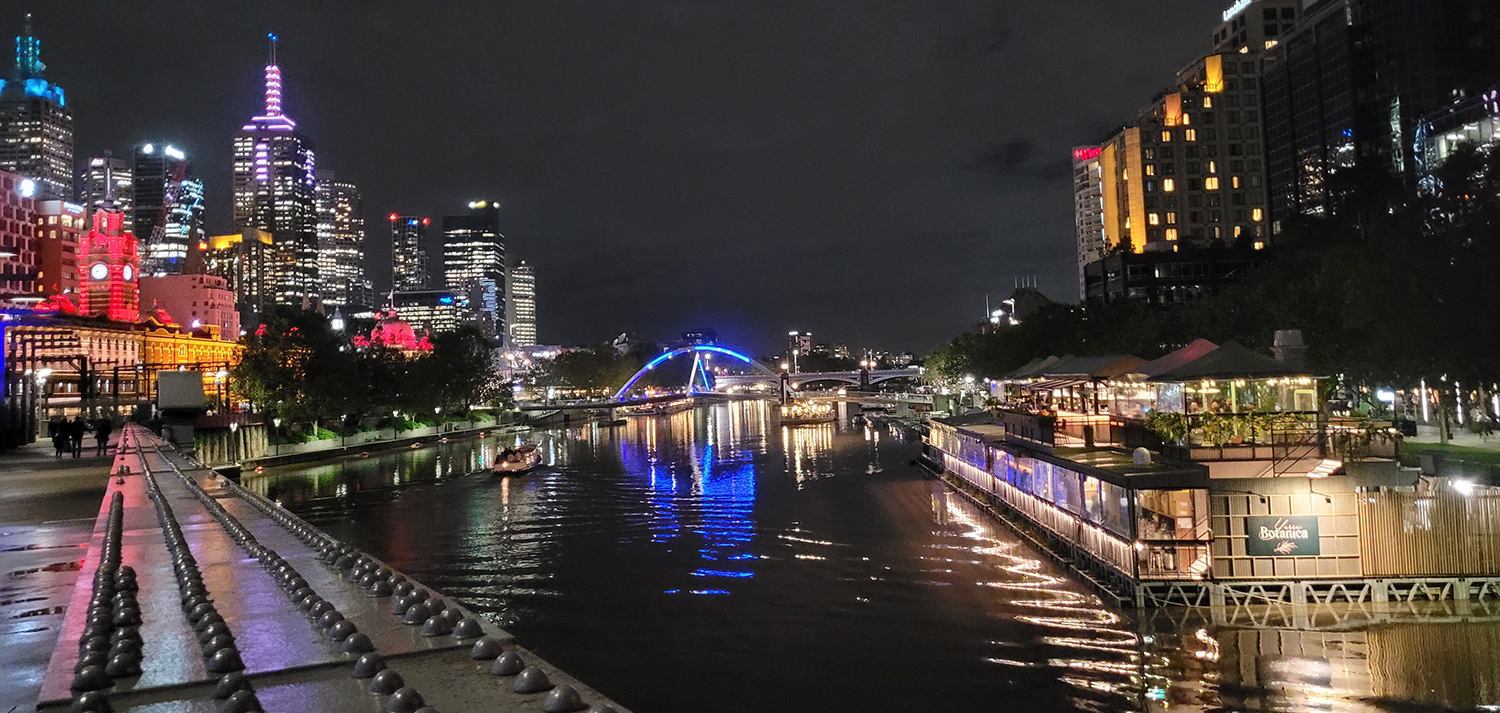 Night-time on the Yarra River as the lights reflect on the water.
