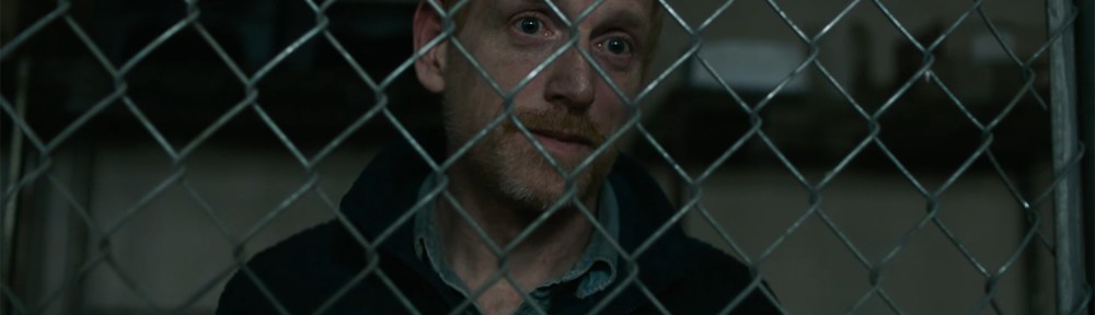 David talks menacingly from behind a cage.