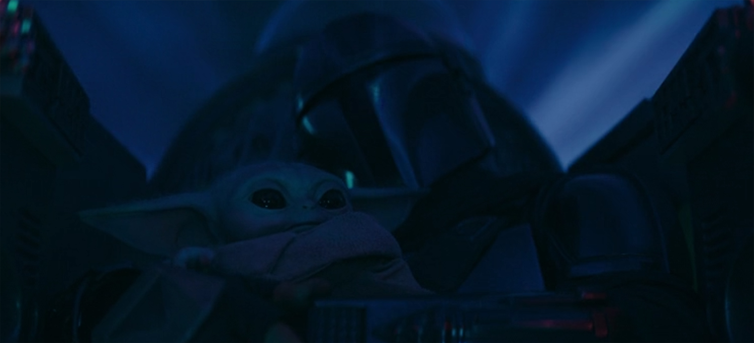 Grogu and Mando in the cockpit of his fighter during hyperspace.