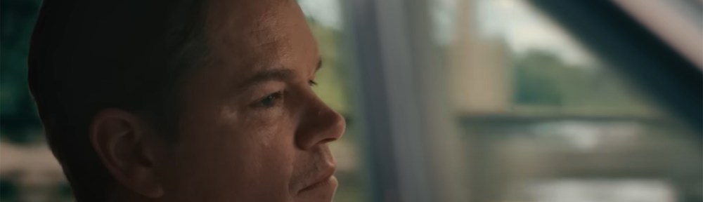 Matt Damon drives a car.