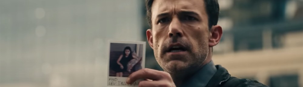 Ben holds up the phot of his missing daughter.