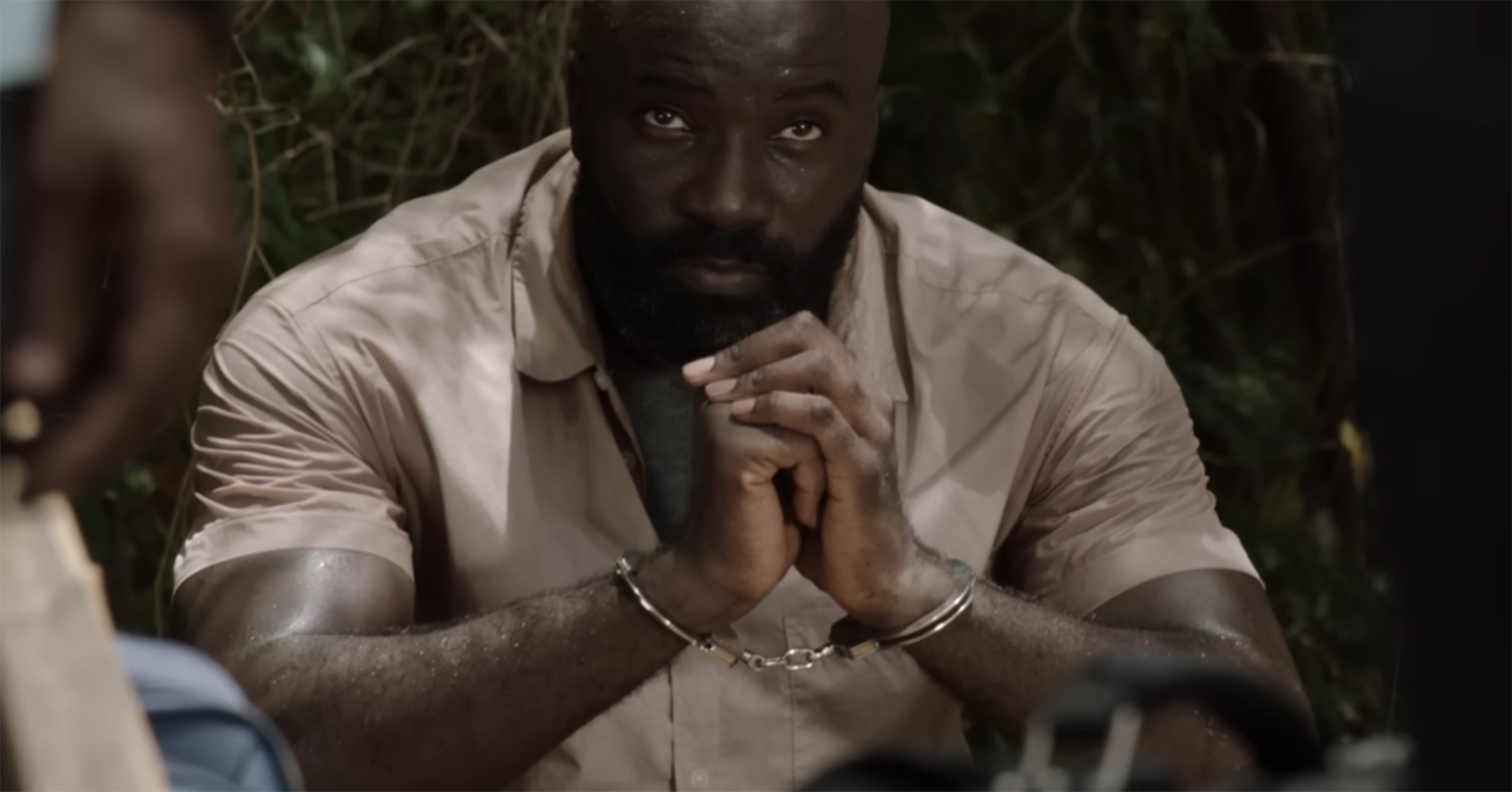 Mike Colter in handcuffs