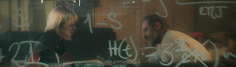 lovers sit while equations adorn a clear whiteboard.