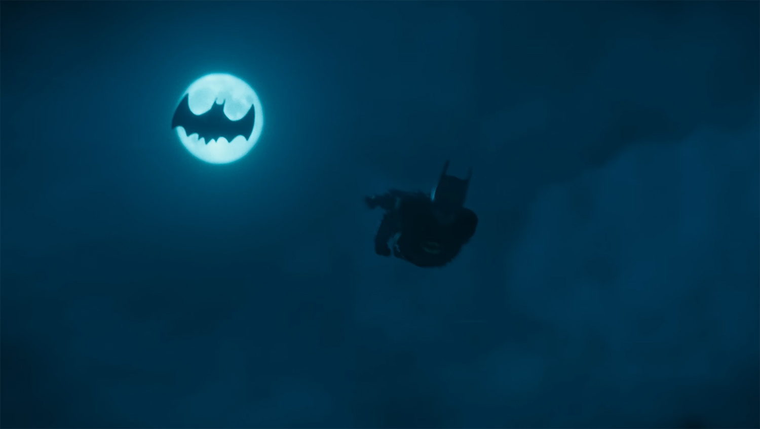 Batman jumps out of the Batwing