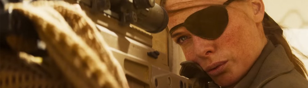 Ilsa Faust looking down a sniper barrel.