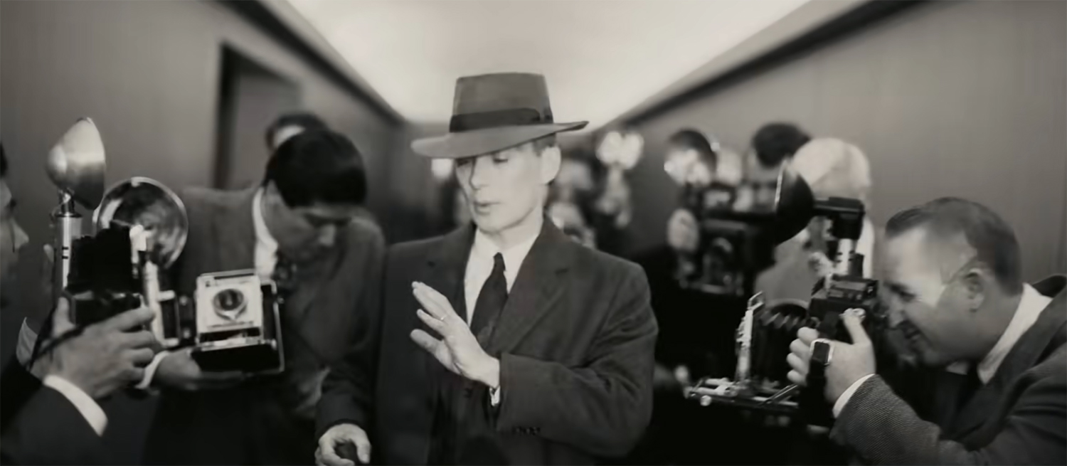 Oppenheimer confronted by photographers.