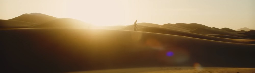 Stone walks across sand dunes.