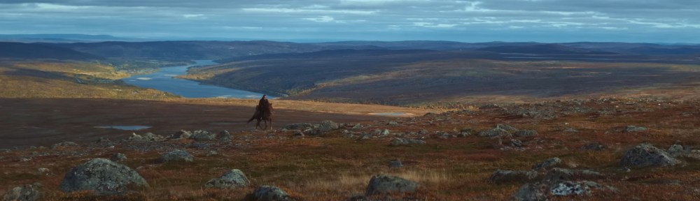 A horse rides over the Lapland countryside.