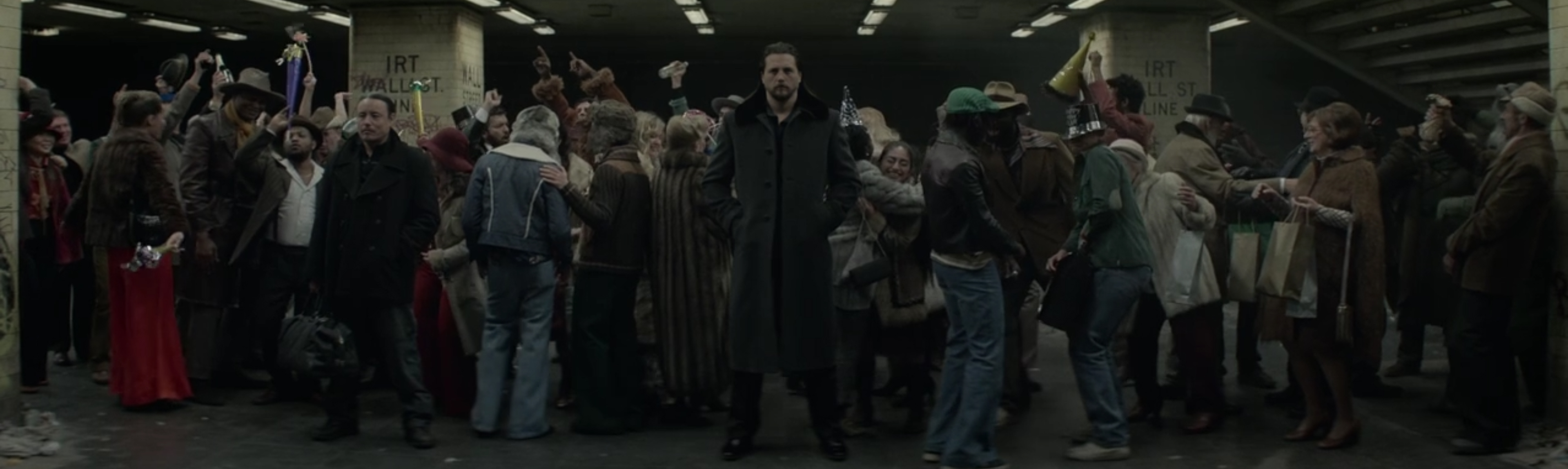 Standing alone in a crowded subway platform.