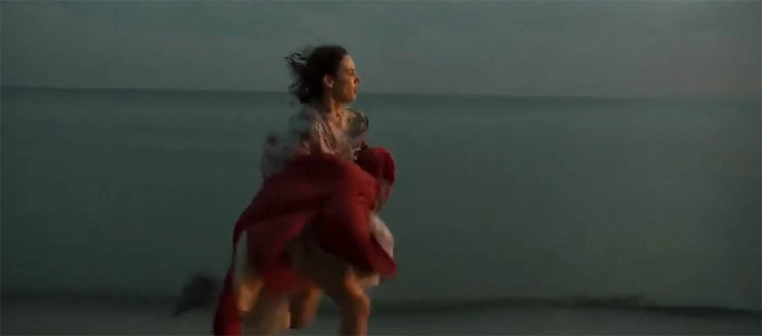 Lena running down the beach.