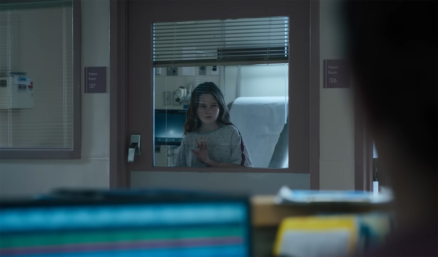 Katherine looks out a hospital window.