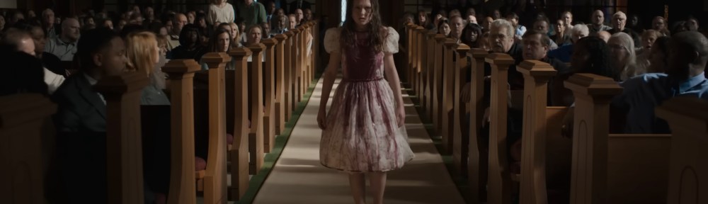 Katherine walks down the ailse of a church covered in communion wine.