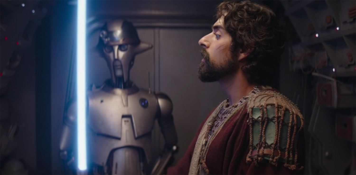 Ezra looks at his new light sabre.