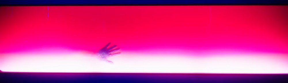 A hand appears out of red fluid.