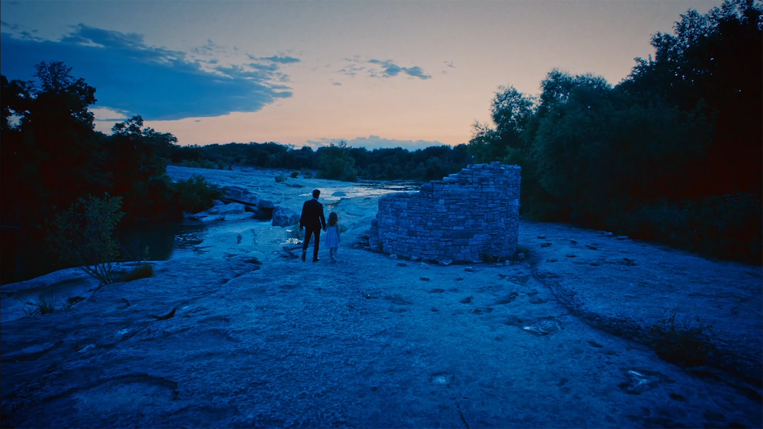 A man takes a girl back to a well.