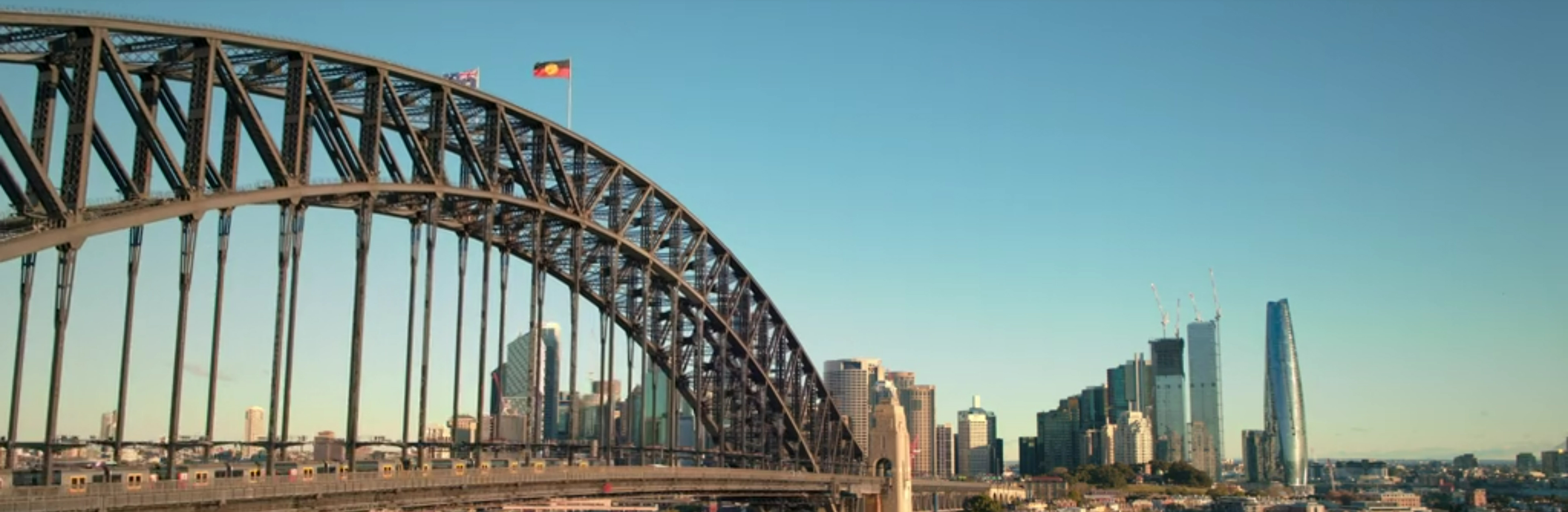 The Sydney Harbour Bridge with Indegenous Flag flying.