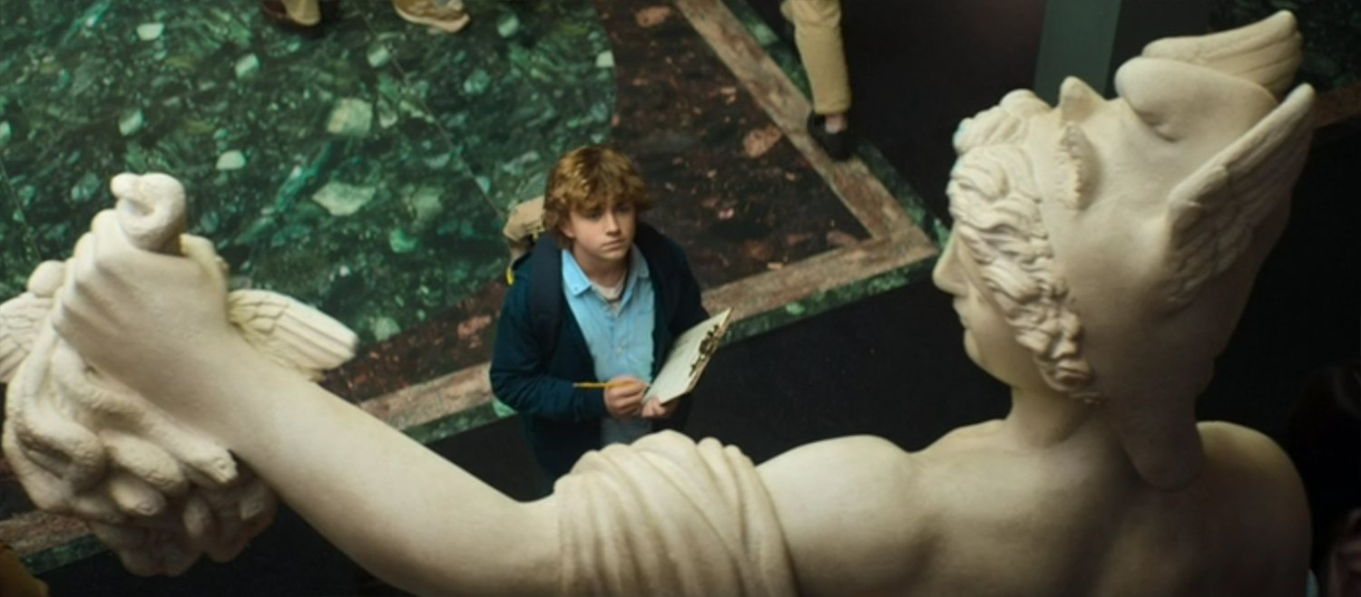 Percy looks at a stature of Percious holding the head of Medusa
